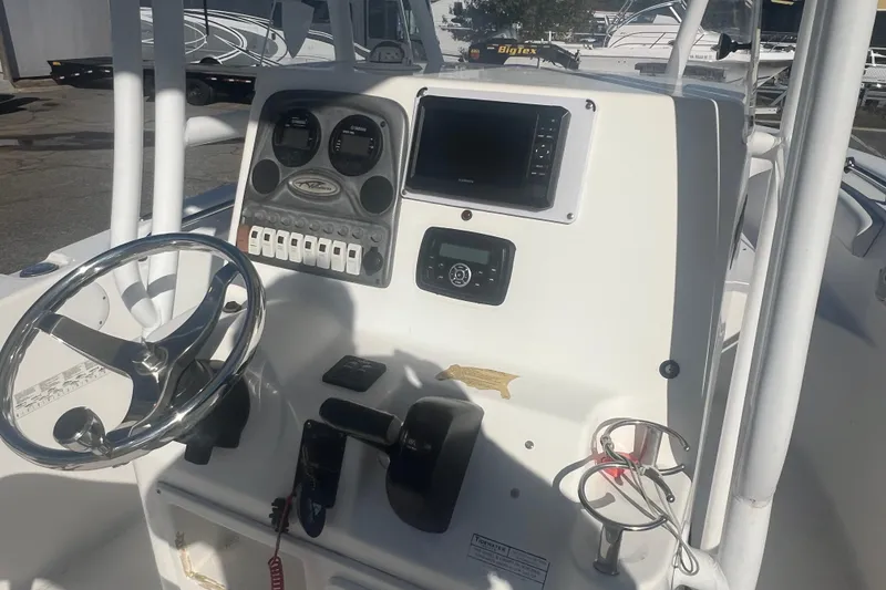Slide: The Image of 2013 Tidewater 216 CC Adventure boat console with steering wheel and controls. - 8