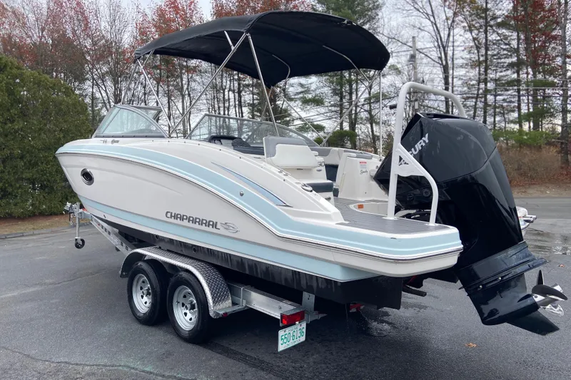 The Image of 2021 Chaparral 230 Suncoast boat on trailer with Mercury outboard motor. - 1