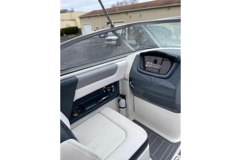 Slide: The Image of Interior of 2021 Chaparral 230 Suncoast boat with seating and dashboard details. - 14