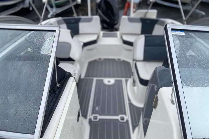 Slide: The Image of Interior view of 2021 Chaparral 230 Suncoast boat with wet seats and flooring. - 16