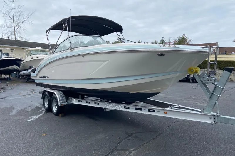 Slide: The Image of 2021 Chaparral 230 Suncoast boat on trailer, parked outdoors. - 3