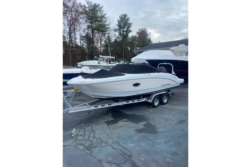 Slide: The Image of 2021 Chaparral 230 Suncoast boat on trailer, covered, in outdoor setting. - 4