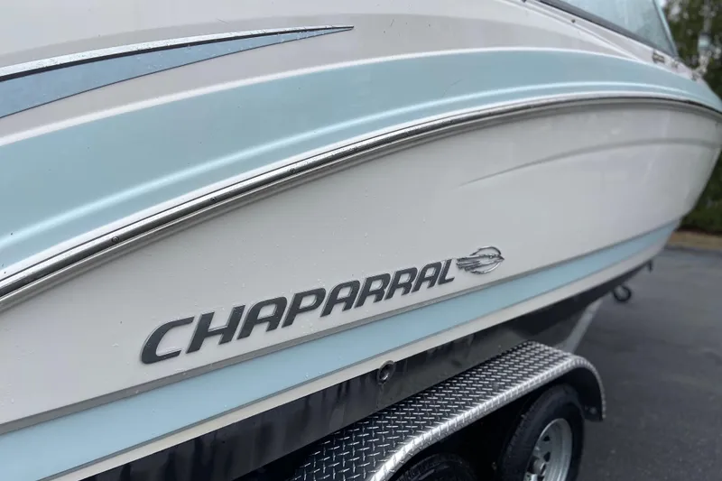 Slide: The Image of 2021 Chaparral 230 Suncoast boat side view with logo and trailer. - 9