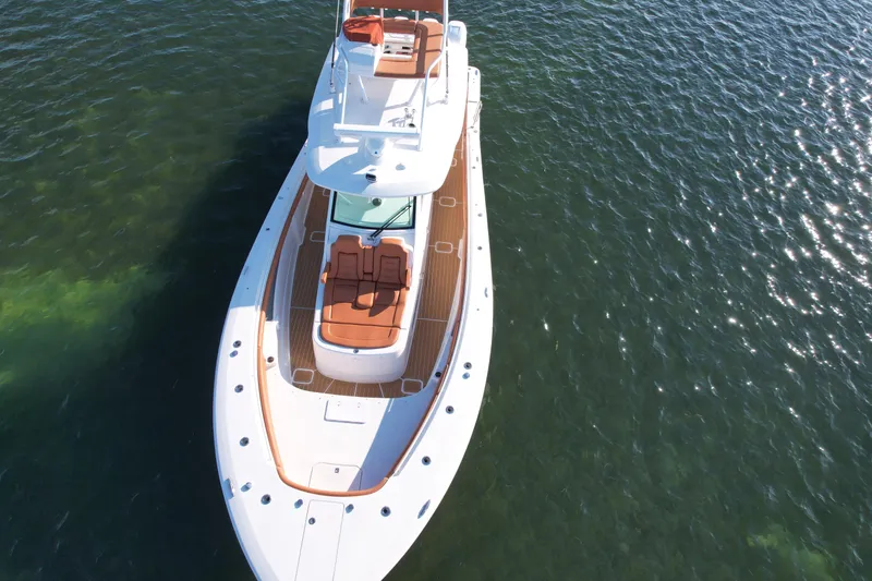 Slide: The Image of 2019 Scout 420 LXF luxury boat on clear water, aerial view. - 11