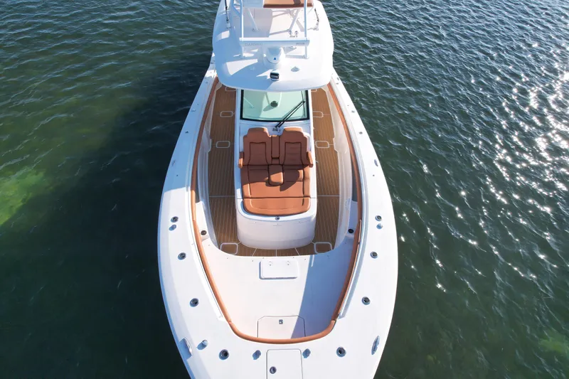 Slide: The Image of 2019 Scout 420 LXF boat on water, aerial view showcasing deck and seating. - 3