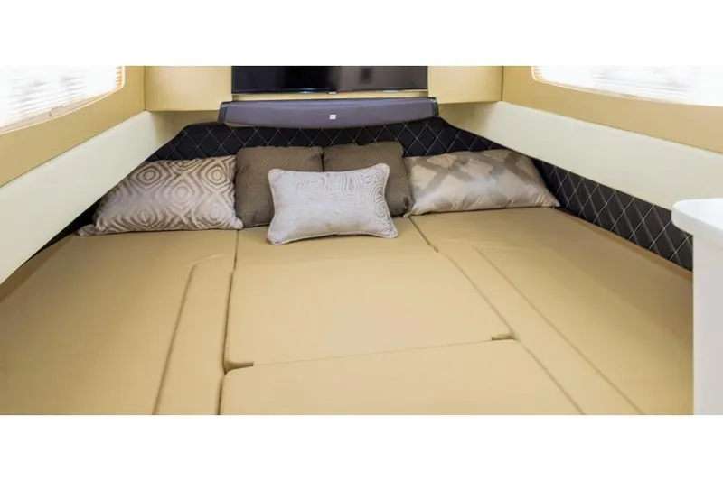 Slide: The Image of Manufacturer Provided Image: 2019 Scout 420 LXF cabin interior with beige bedding and decorative pillows. - 33