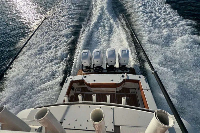 Slide: The Image of 2019 Scout 420 LXF boat with four engines cruising on water, leaving a wake. - 41