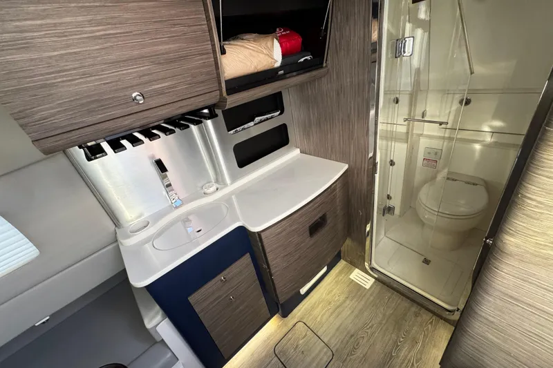 Slide: The Image of Luxurious 2019 Scout 420 LXF boat interior with modern bathroom and sleek cabinetry. - 45