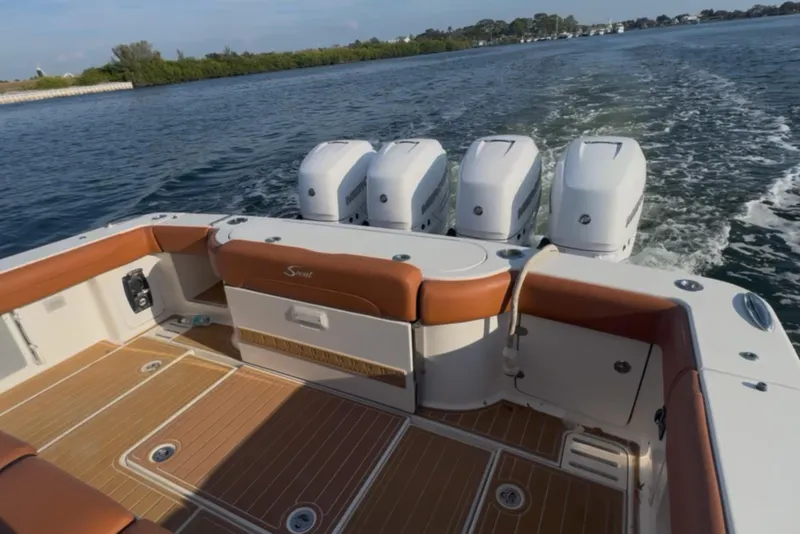 Slide: The Image of 2019 Scout 420 LXF boat with quad engines cruising on open water. - 49