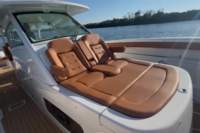 Slide: The Image of Luxurious seating on 2019 Scout 420 LXF boat, with scenic water view. - 51