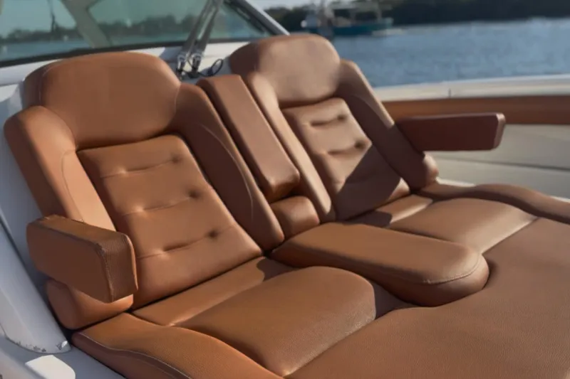 Slide: The Image of Luxurious leather seating on 2019 Scout 420 LXF boat, with scenic water backdrop. - 52