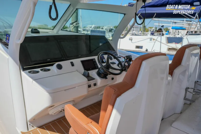 Slide: The Image of 2019 Scout 420 LXF boat helm with modern controls and leather seating. - 54