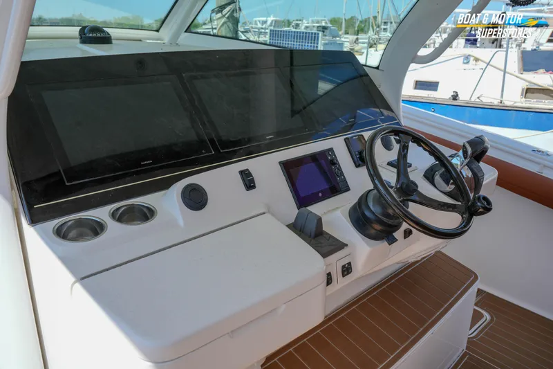 Slide: The Image of Helm of 2019 Scout 420 LXF boat with modern navigation displays and steering wheel. - 55