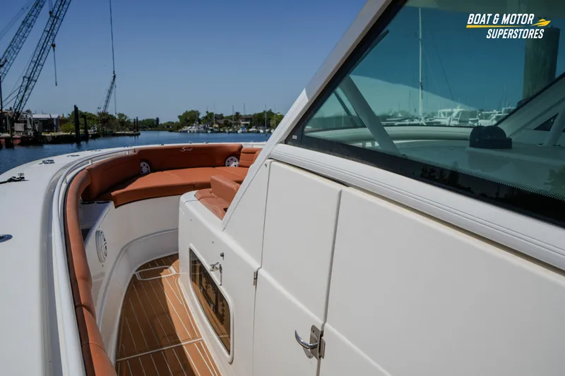 Slide: The Image of 2019 Scout 420 LXF boat with luxurious seating and sleek design on the water. - 56