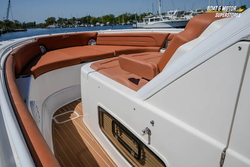 Slide: The Image of 2019 Scout 420 LXF boat interior with tan seating and wood flooring. - 57