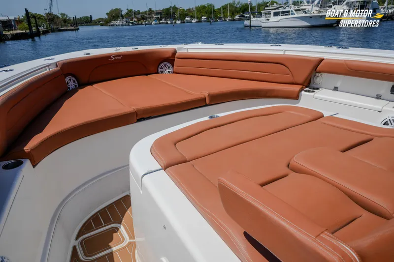 Slide: The Image of Luxurious seating on 2019 Scout 420 LXF boat, docked by the waterfront. - 58