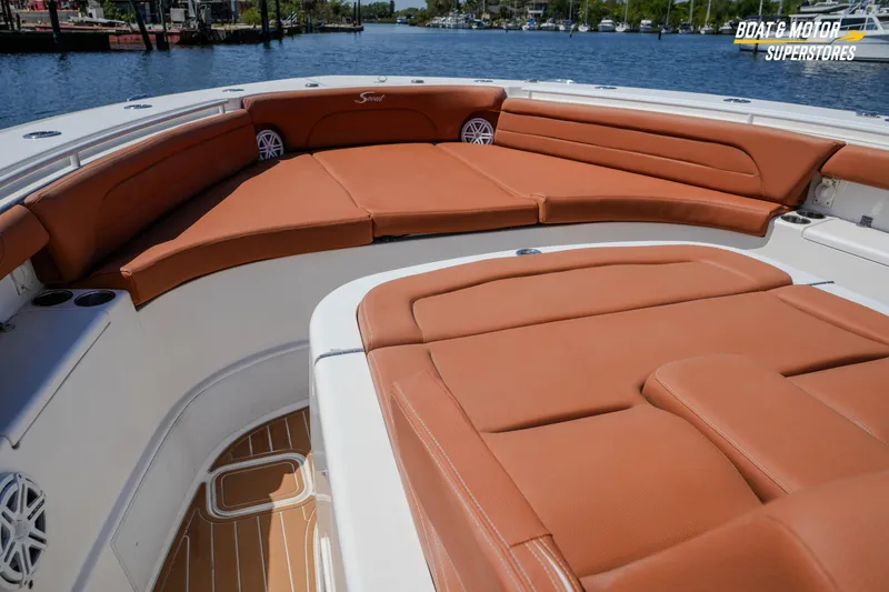 Slide: The Image of Luxurious seating on 2019 Scout 420 LXF boat, featuring tan leather upholstery and spacious deck. - 59