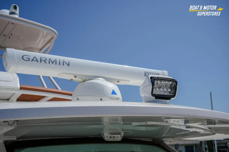 Slide: The Image of 2019 Scout 420 LXF boat with Garmin radar and spotlight under clear blue sky. - 67