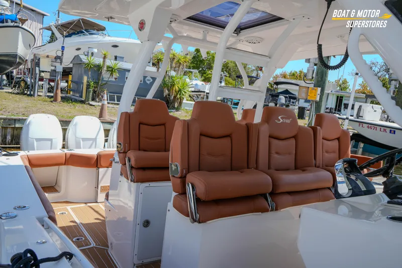 Slide: The Image of 2019 Scout 420 LXF boat interior with brown leather seating and modern helm. - 69
