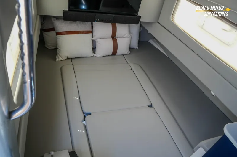 Slide: The Image of Interior cabin of 2019 Scout 420 LXF boat with cushions and a TV. - 74