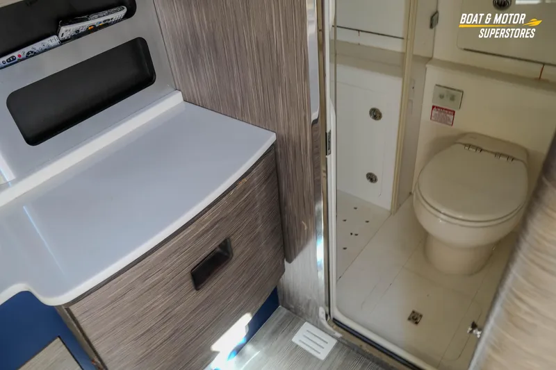 Slide: The Image of 2019 Scout 420 LXF boat interior featuring a compact bathroom with modern amenities. - 75