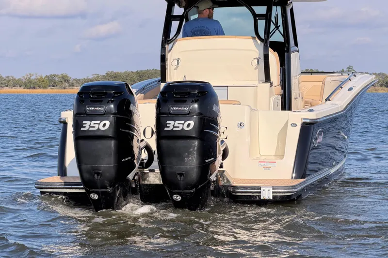Slide: The Image of 2022 Scout 330 LXF boat with twin 350 Verado engines on water. - 13