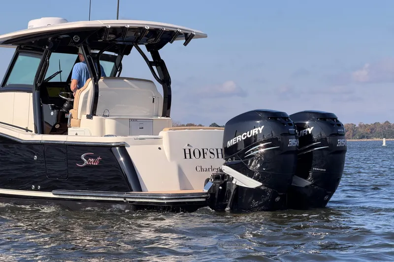 Slide: The Image of 2022 Scout 330 LXF boat with dual Mercury engines on the water. - 14