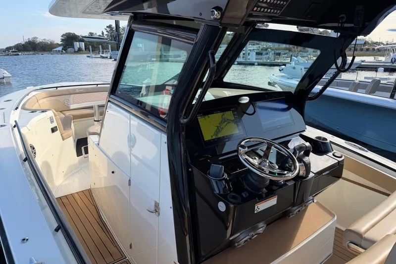 Slide: The Image of 2022 Scout 330 LXF boat interior with modern helm and navigation system. - 18