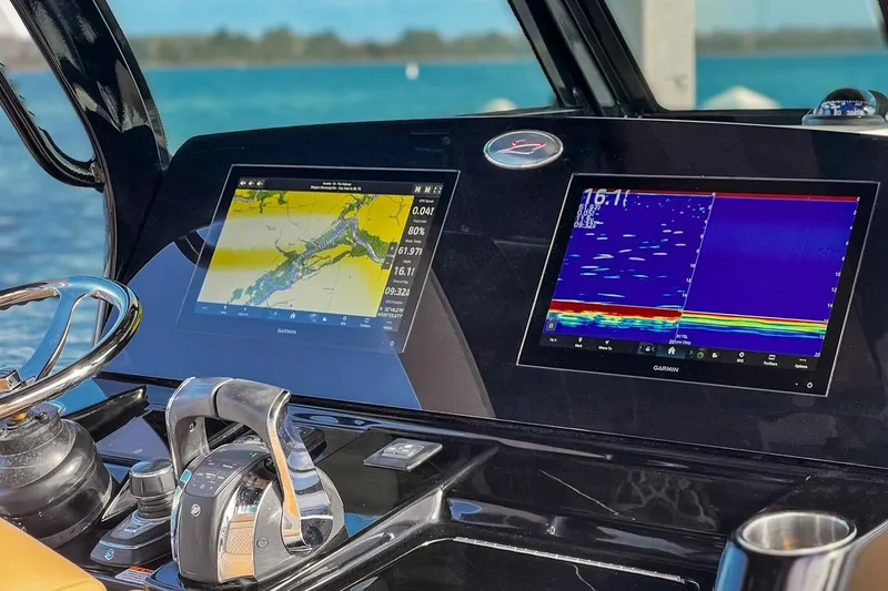 Slide: The Image of 2022 Scout 330 LXF boat dashboard with Garmin navigation displays. - 22