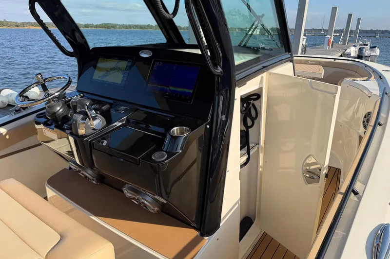 Slide: The Image of 2022 Scout 330 LXF boat interior with advanced navigation system and luxurious seating. - 23