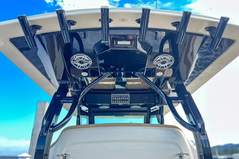 Slide: The Image of 2022 Scout 330 LXF boat with sleek black T-top and integrated speakers. - 25