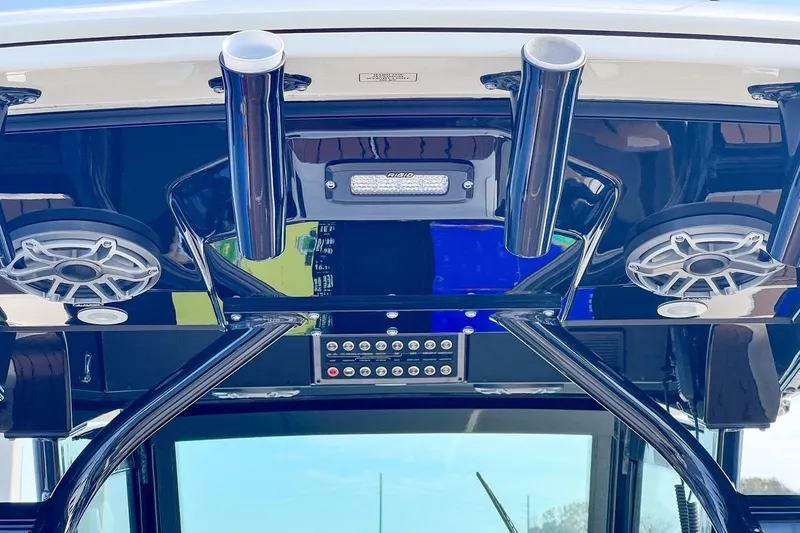 Slide: The Image of 2022 Scout 330 LXF boat dashboard with speakers and rod holders. - 26