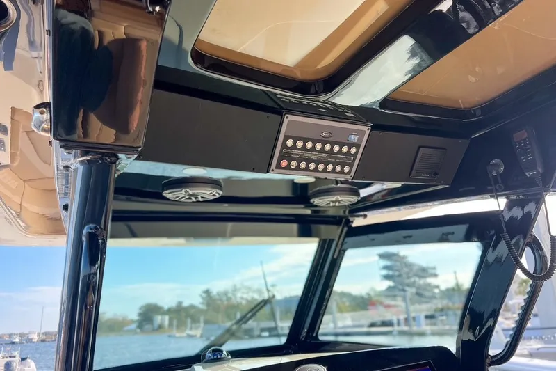 Slide: The Image of Interior view of 2022 Scout 330 LXF boat's control panel and speakers. - 27