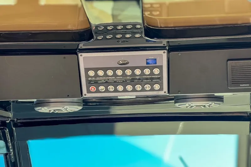Slide: The Image of Control panel of a 2022 Scout 330 LXF boat with switches and speakers. - 28