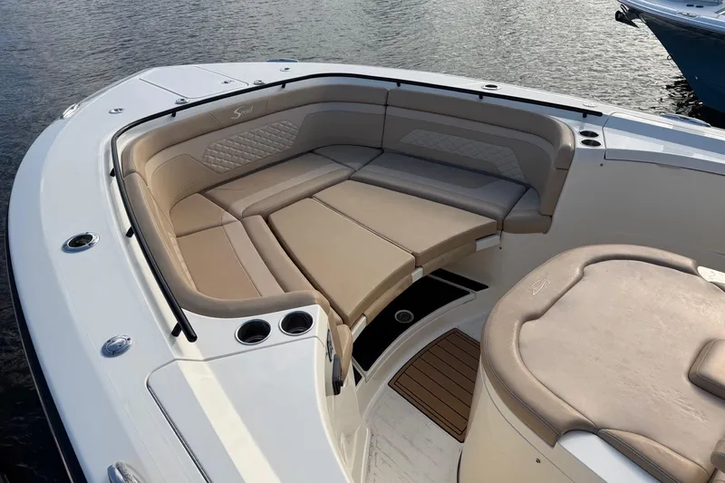 Slide: The Image of Luxurious seating area on 2022 Scout 330 LXF boat, featuring beige upholstery. - 31