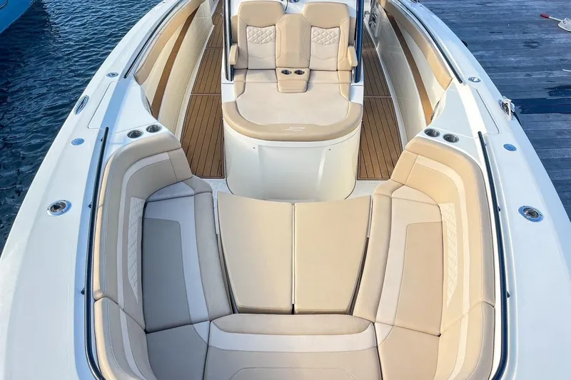 Slide: The Image of Luxurious 2022 Scout 330 LXF boat interior with beige seating and wooden flooring. - 33