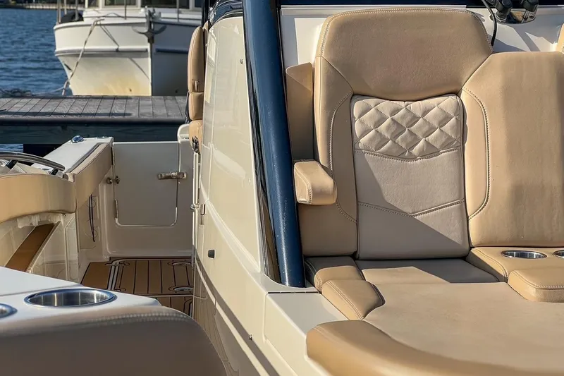 Slide: The Image of 2022 Scout 330 LXF boat interior with luxurious seating and cup holders. - 38