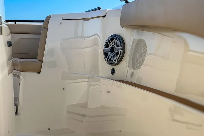 Slide: The Image of 2022 Scout 330 LXF boat interior with speaker and beige seating. - 40