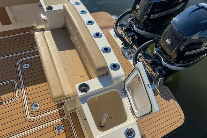 Slide: The Image of 2022 Scout 330 LXF boat deck with seating and dual Mercury engines. - 48