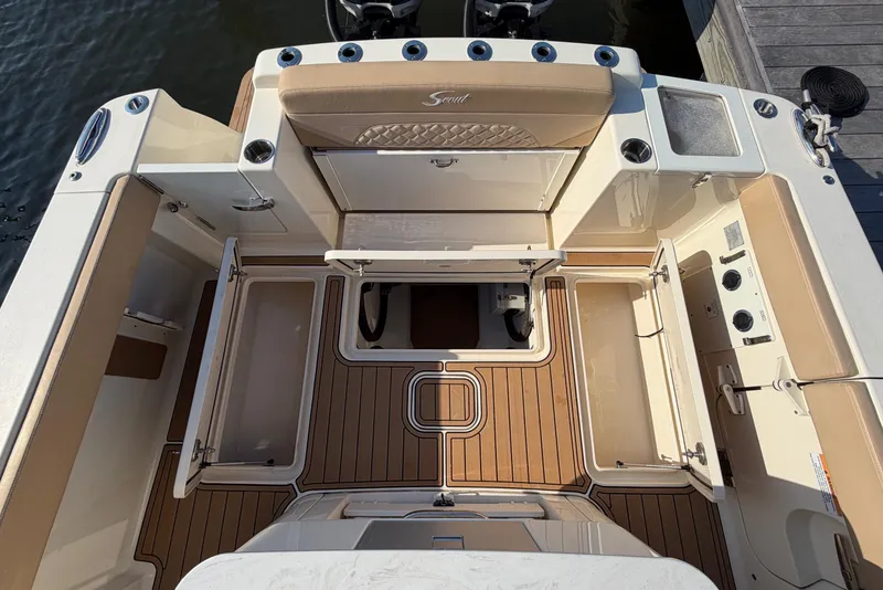 Slide: The Image of 2022 Scout 330 LXF boat interior with teak flooring and storage compartments. - 51