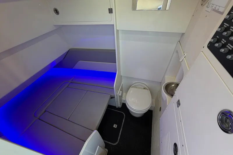 Slide: The Image of 2022 Scout 330 LXF cabin interior with seating, toilet, and blue ambient lighting. - 53