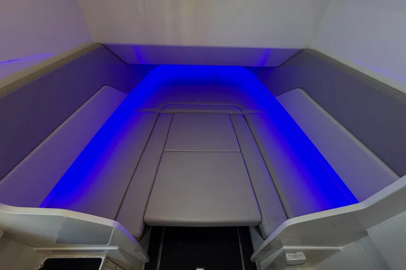 Slide: The Image of 2022 Scout 330 LXF boat interior with blue LED lighting. - 54