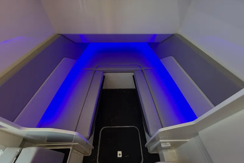 Slide: The Image of 2022 Scout 330 LXF interior with blue LED lighting and cushioned seating. - 55