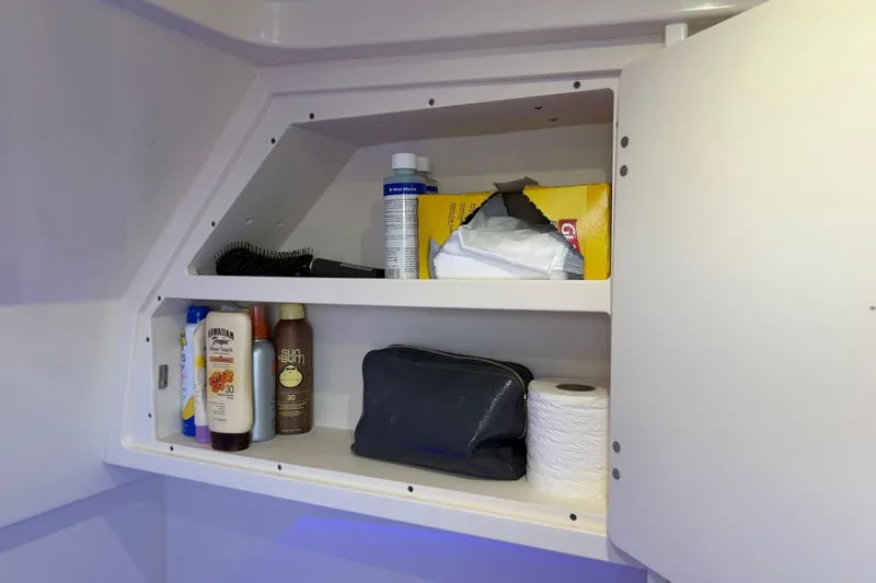 Slide: The Image of Cabinet storage in 2022 Scout 330 LXF boat with toiletries and essentials. - 59