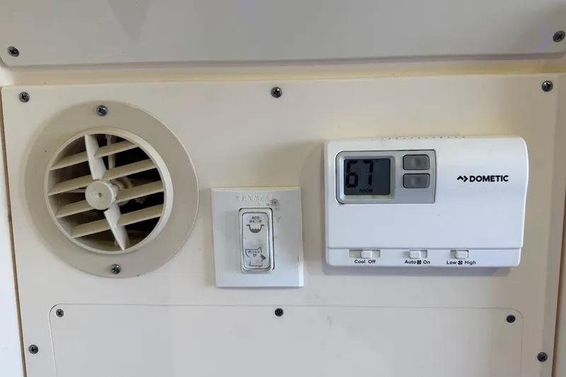 Slide: The Image of Dometic thermostat and vent control panel in 2022 Scout 330 LXF boat. - 61