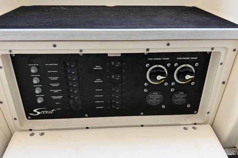 Slide: The Image of Control panel of 2022 Scout 330 LXF boat with various switches and meters. - 62