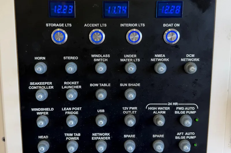 Slide: The Image of Control panel of a 2022 Scout 330 LXF boat with various switches and displays. - 63