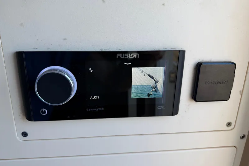 Slide: The Image of Fusion audio system and Garmin device on 2022 Scout 330 LXF boat dashboard. - 64