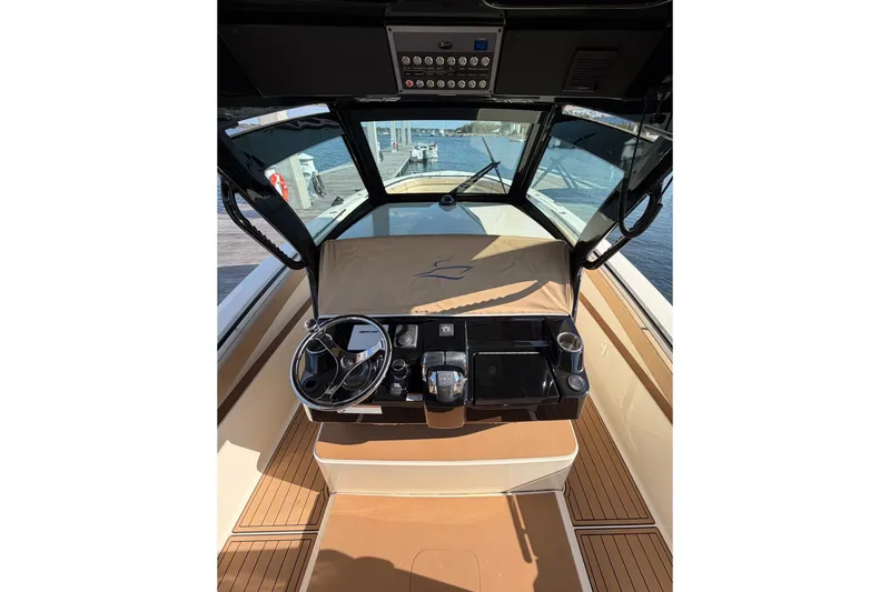 Slide: The Image of 2022 Scout 330 LXF boat helm with modern controls and wooden deck. - 70