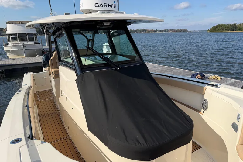 Slide: The Image of 2022 Scout 330 LXF boat docked, featuring Garmin equipment and sleek design. - 71